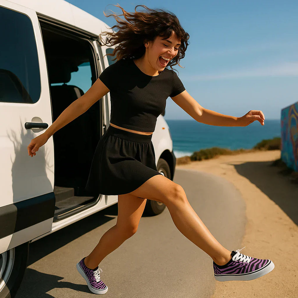 A girl joyfully jumping in trendy shoes near a van by the beach