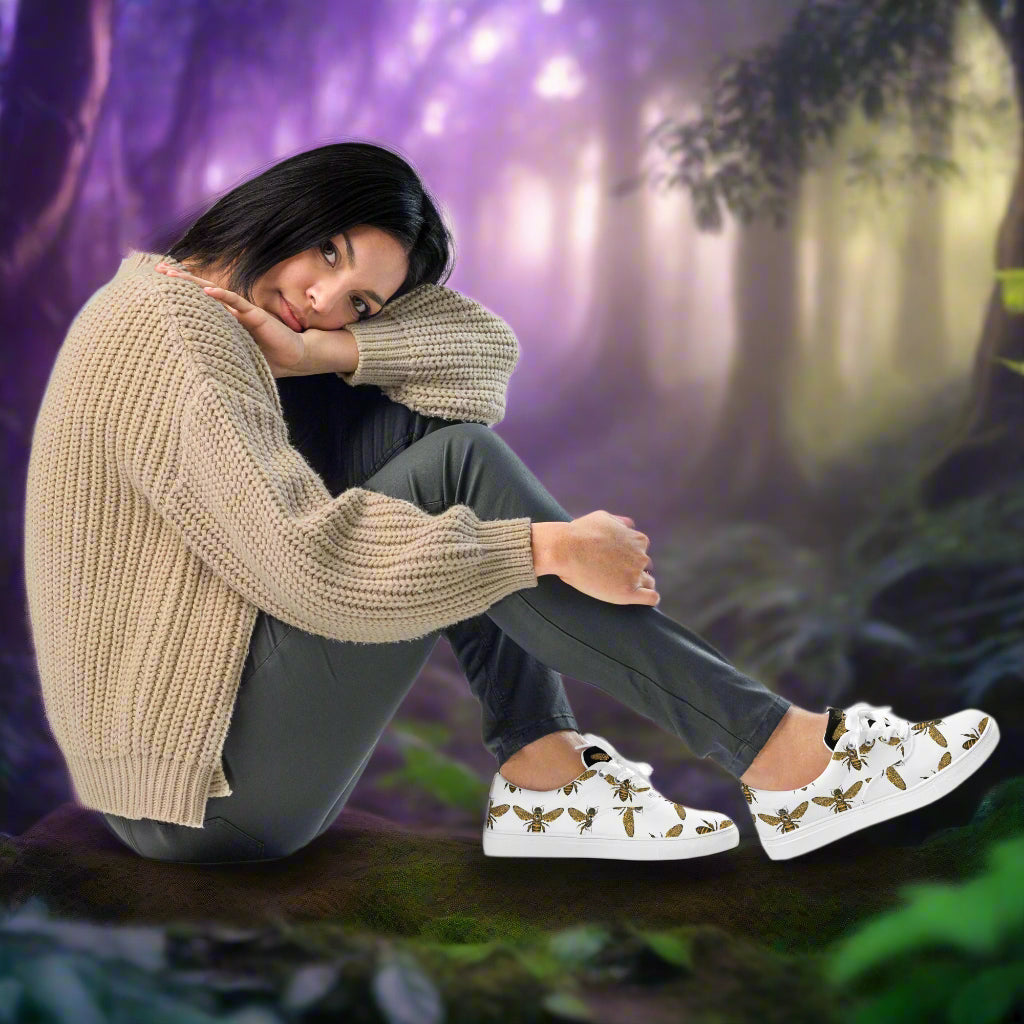 WildSage Market lace-up canvas shoes with bee print worn by woman sitting outdoors