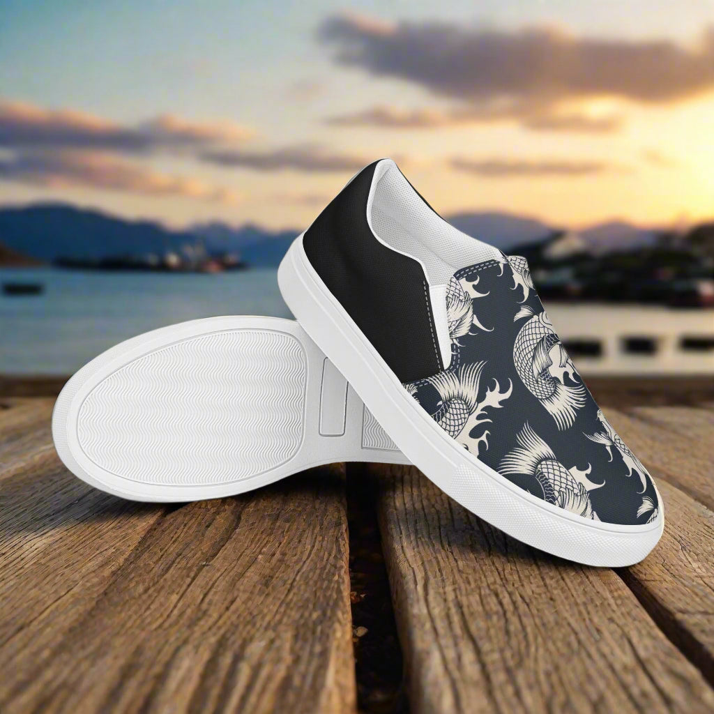 Black Koi Halftone Slip-on Canvas Shoes with unique design on a wooden surface by the water