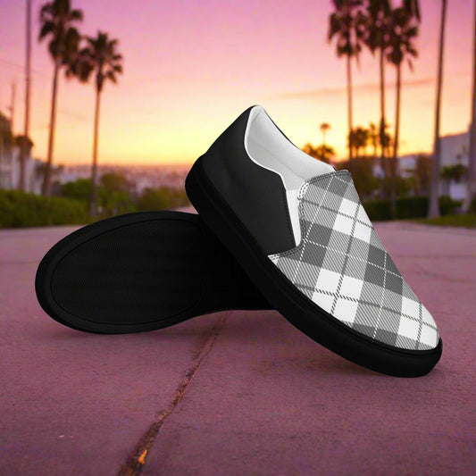 Black Plaid Halftone Slip-On Canvas Shoes from WildSage Market displayed outdoors at sunset