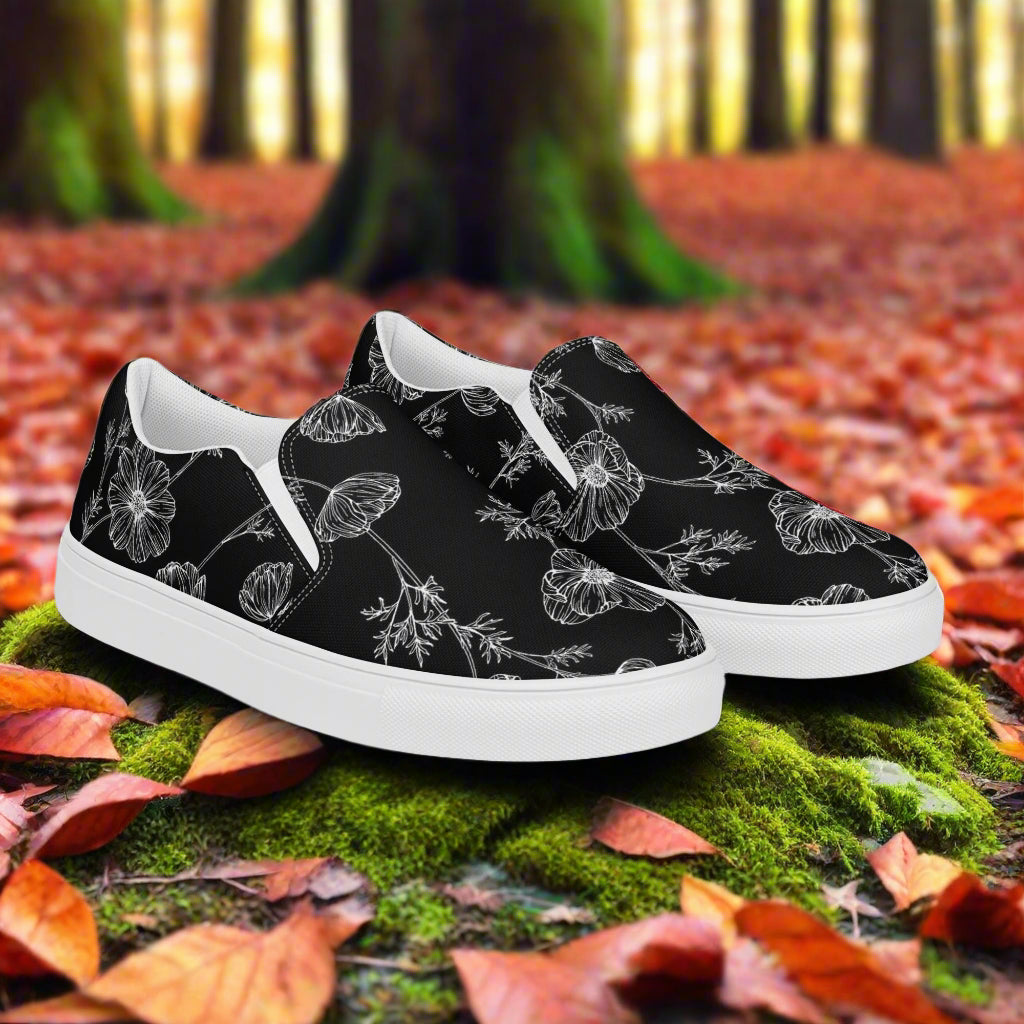 Black Poppy Slip-on Canvas Shoes featuring a floral design on a white sole, perfect for casual wear