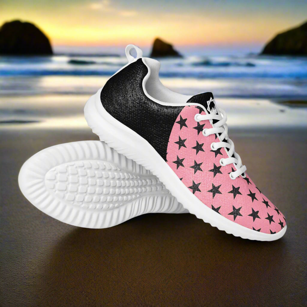 Black Stars Pink Halftone Womens Athletic Shoes by WildSage Market with white soles on a beach background