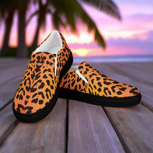 WildSage Market cheetah print slip on shoes with black soles on wooden deck at sunset
