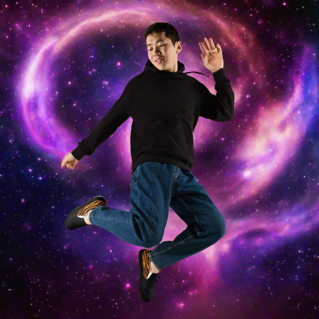 WildSage Market slip on tiger two tone shoes worn by man jumping against galaxy background
