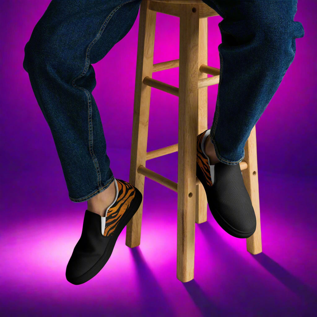 WildSage Market slip on tiger two tone shoes worn with blue jeans sitting on wooden stool