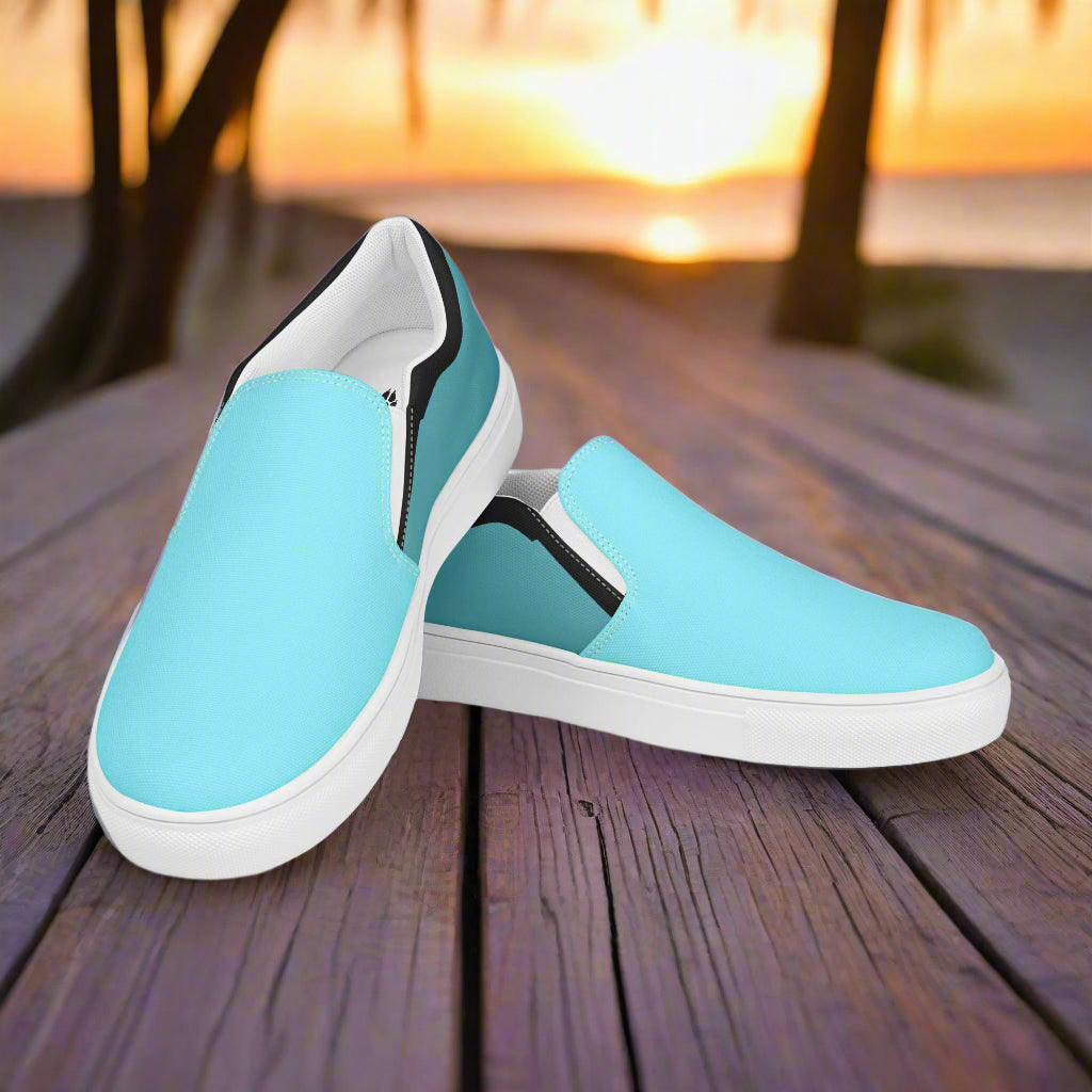 Teal slip on canvas shoes by WildSage Market displayed on wooden surface at sunset