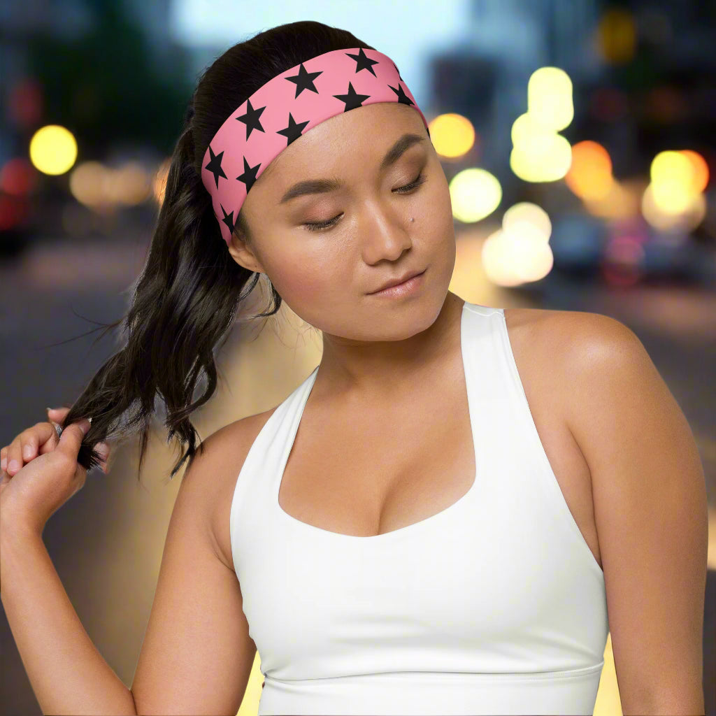 WildSage Market headband pink black stars worn by woman with white tank top in evening city background