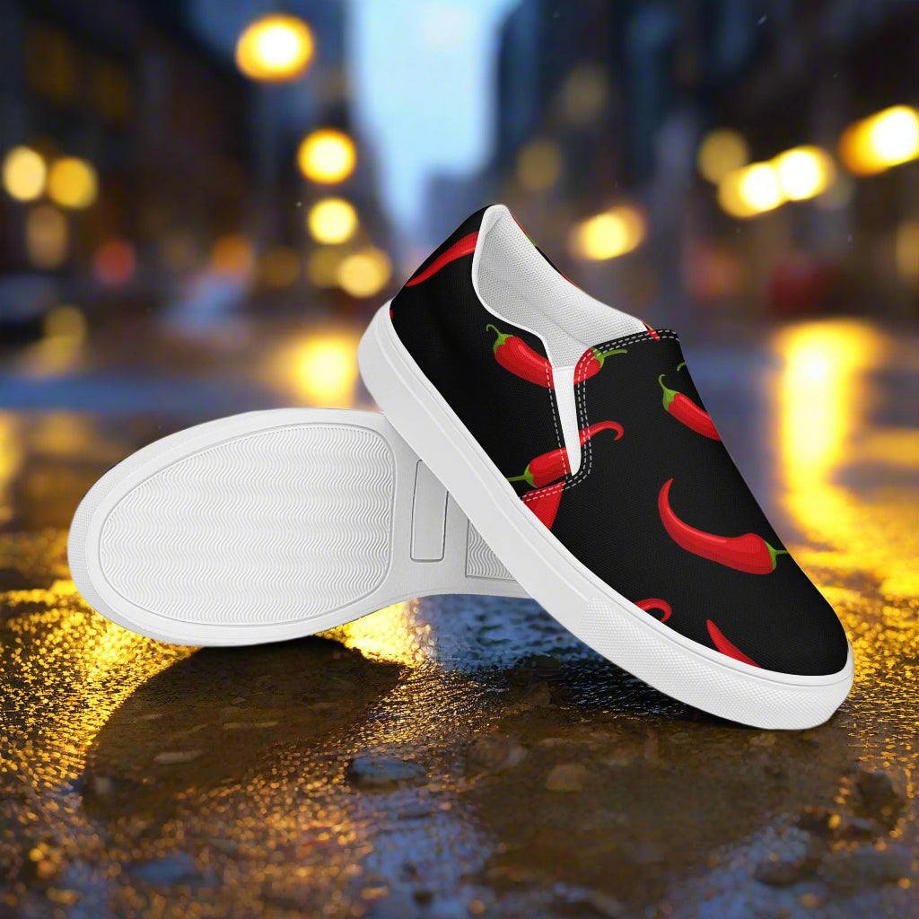 Hot Chili Slip-on Canvas Shoes featuring vibrant chili pepper design on a black background