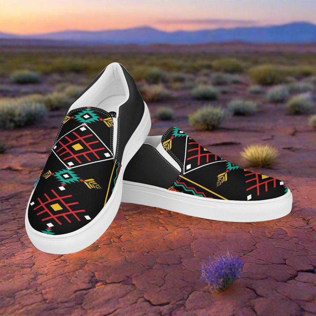 Hualipai Halftone Slip-on Canvas Shoes featuring a vibrant tribal pattern on a desert landscape