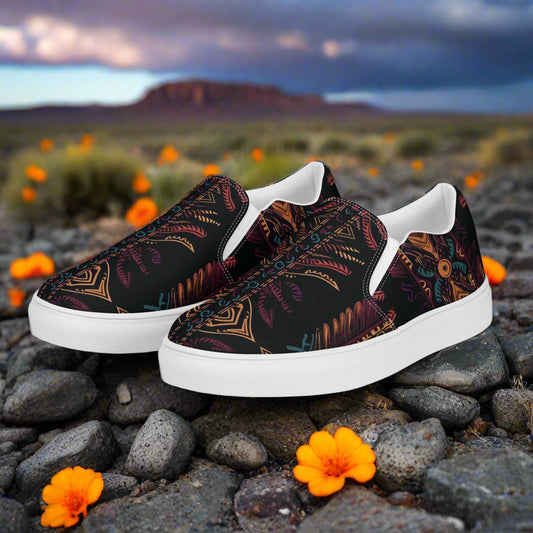 Iktomi Southwest Print Slip-on Canvas Shoes with vibrant patterns on a rocky background