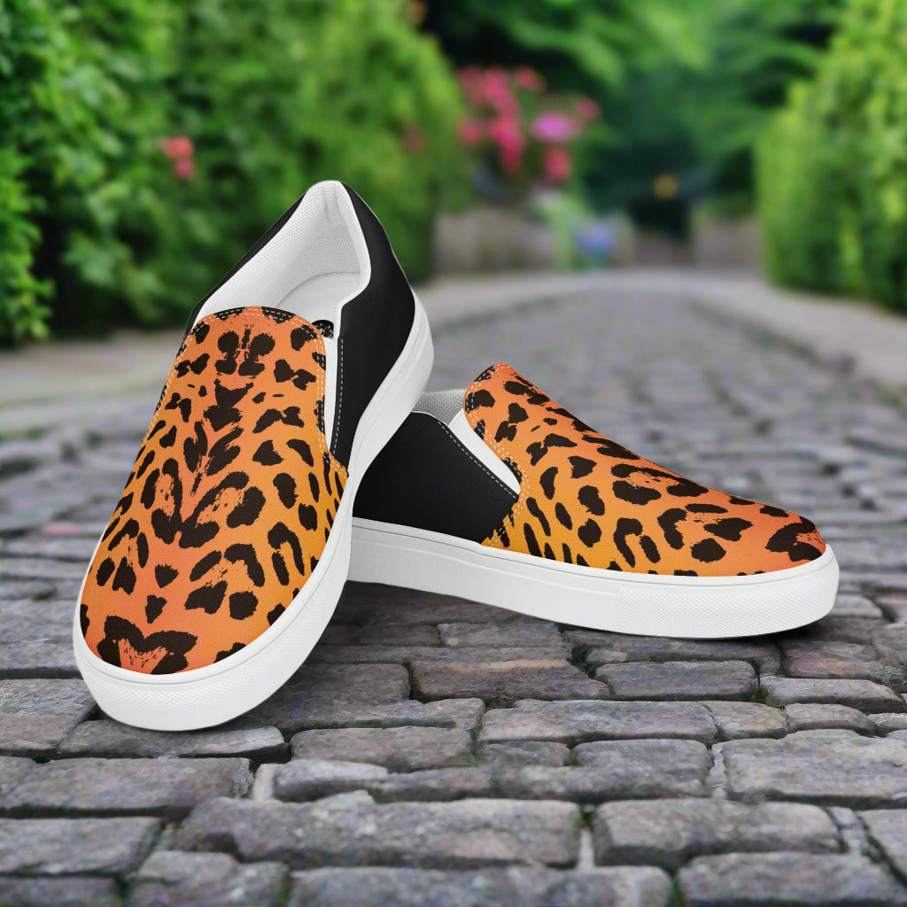 Mens Cheetah Halftone Slip on Canvas Shoes with white soles and black side panels on cobblestone path