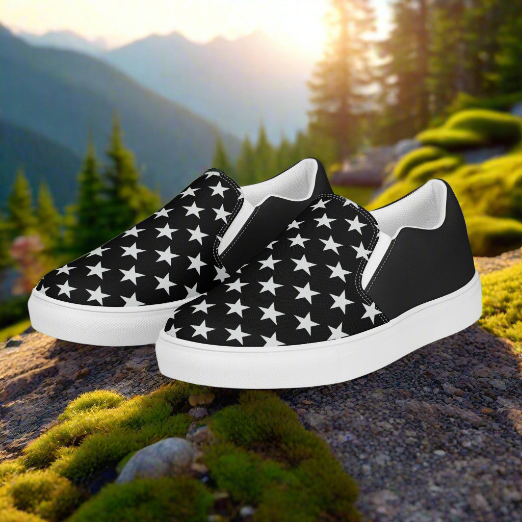 WildSage Market mens star pattern slip-on canvas shoes with a stylish black design against a nature backdrop