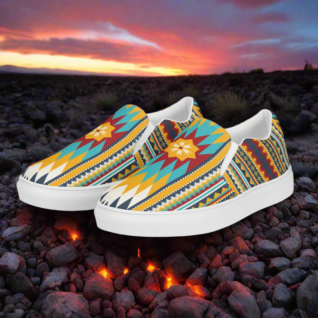 Nakona Southwest Print Slip-on Canvas Shoes featuring vibrant tribal patterns on a scenic background