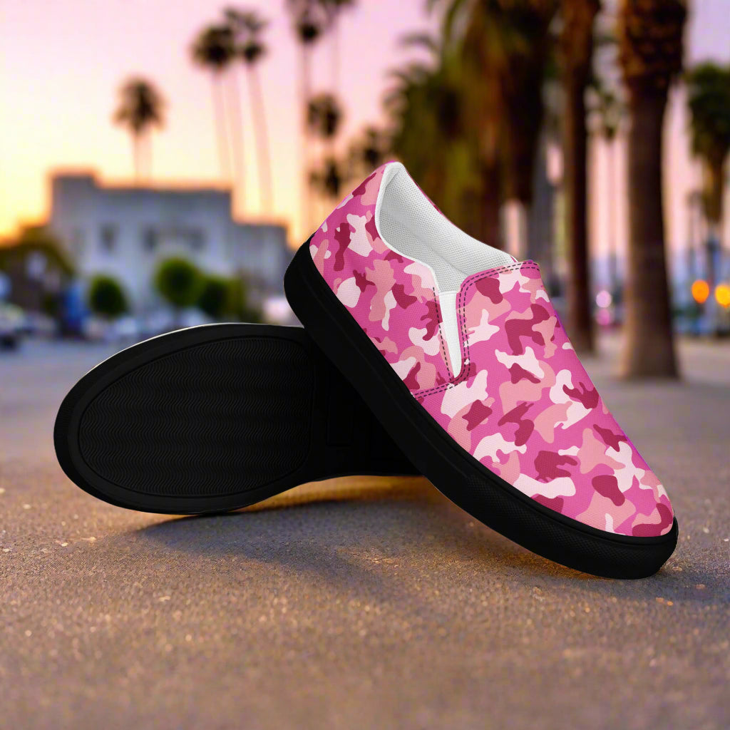 WildSage Market pink camo slip on shoes with black soles on city street at sunset