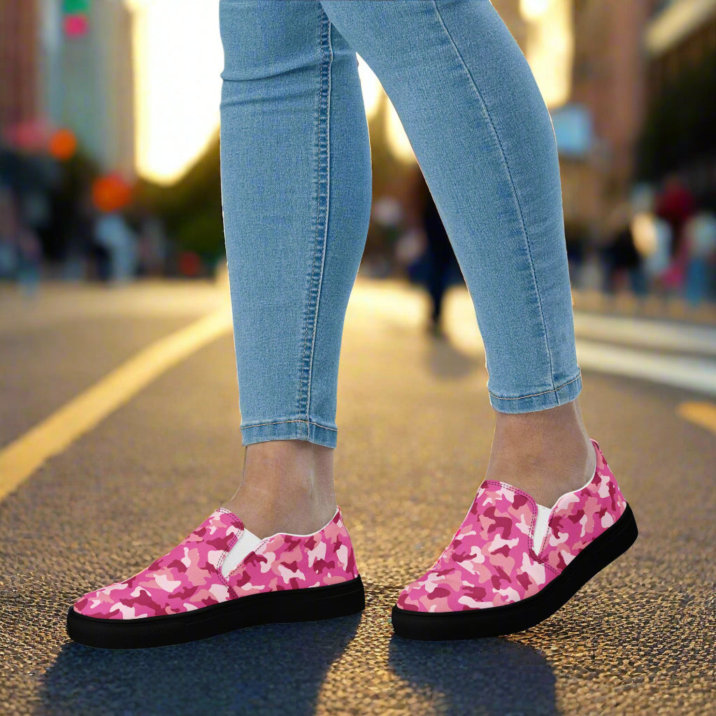 WildSage Market pink camo slip on shoes worn with light blue skinny jeans on street