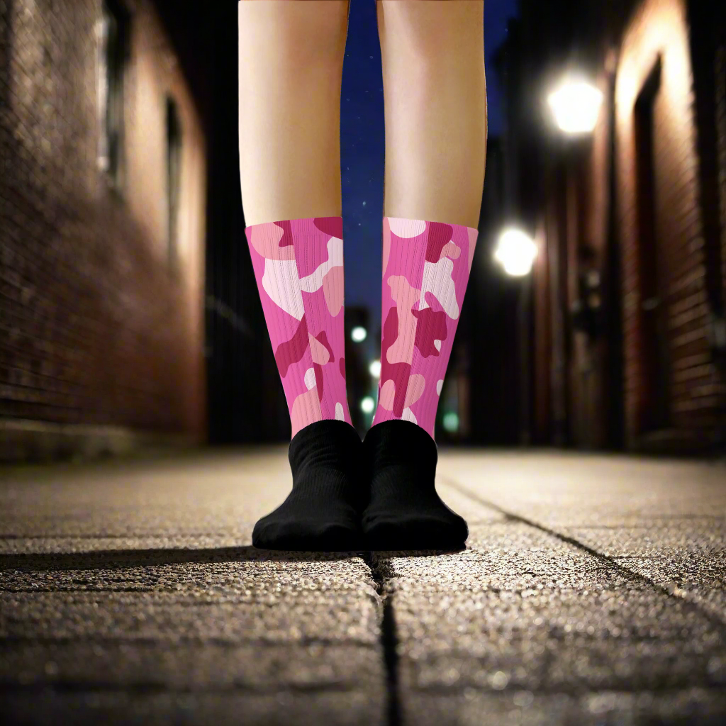 Pink Camo Unisex Black Bottom Socks on feet, perfect for casual and stylish wear