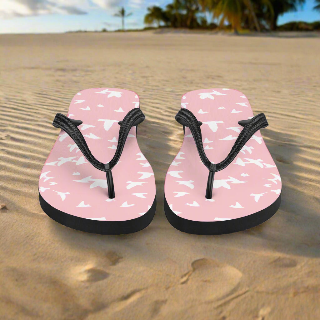 Pink white bird print flip-flops with black straps perfect for beach days and casual wear