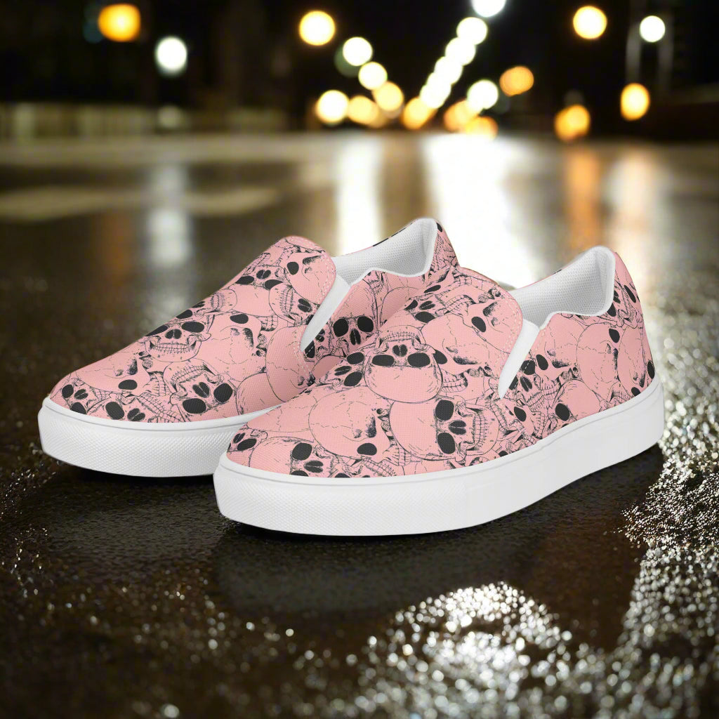 WildSage Market slip on shoes with pink skull pattern and white soles on wet street surface