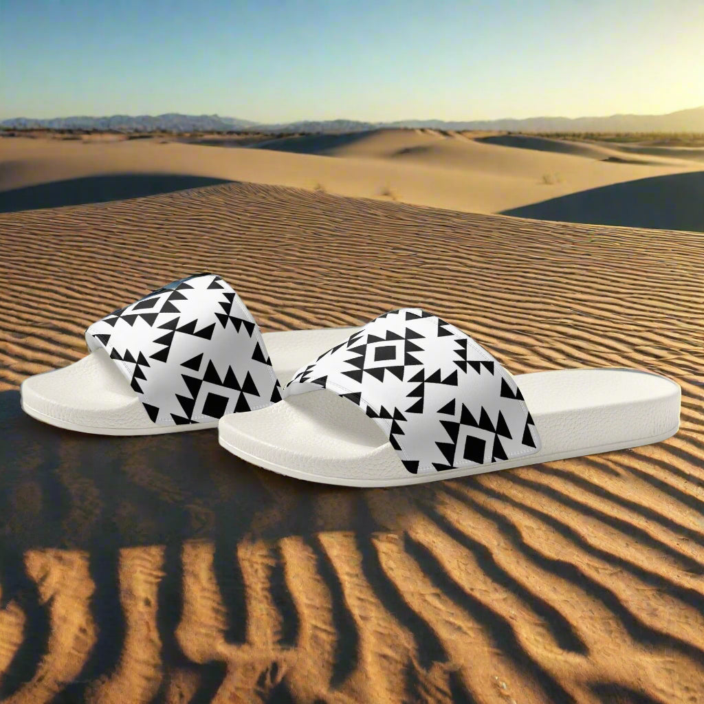 White slides Southwest pattern with black geometric design on desert sand background