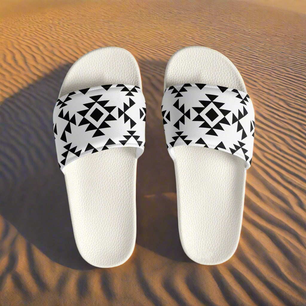 WildSage Market white slides with black Southwest pattern on sandy desert background