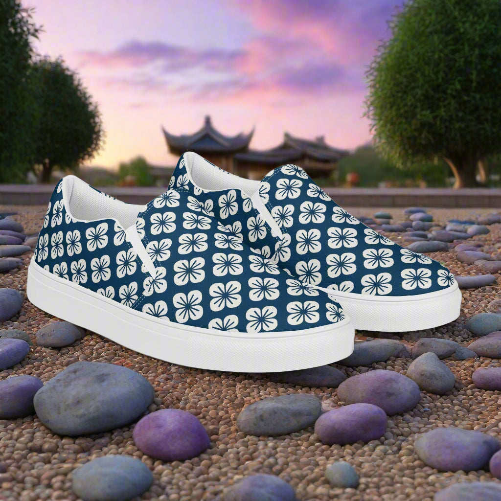 Slip-on Canvas Shoes Asian Floral Pattern in Navy Blue with White Floral Design on a Stony Path