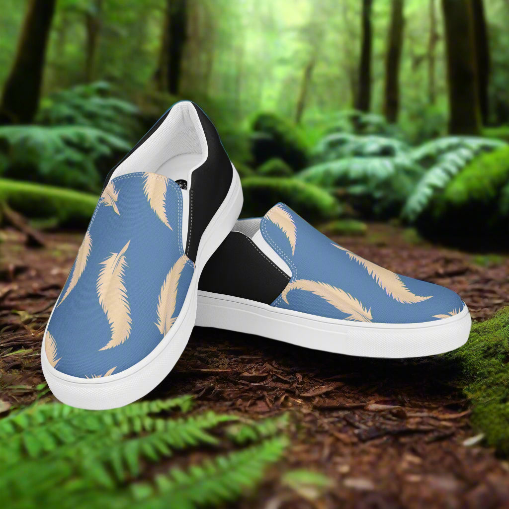 WildSage Market Slip-on Canvas Shoes Blue Feather Halftone design on a forest floor