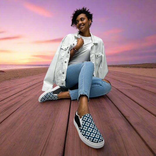Stylish woman wearing Slip-on Canvas Shoes Blue Orchid Halftone on a beach at sunset