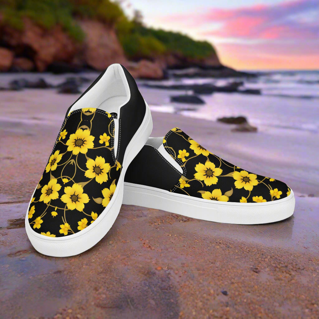 WildSage Market Slip-on Canvas Shoes Floral Yellow Bloom Halftone on a beach with a sunset background