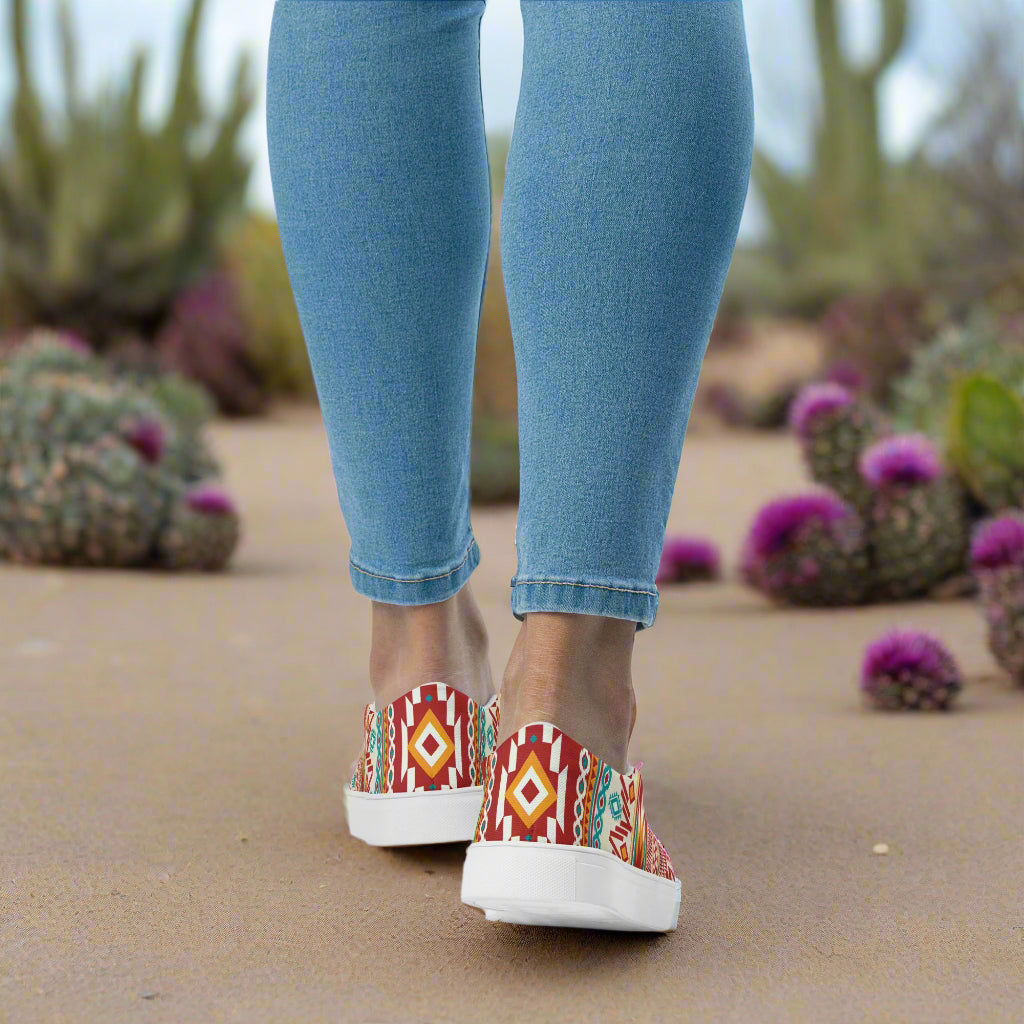 Southwest Nogales print slip on canvas shoes by WildSage Market worn with blue jeans outdoors