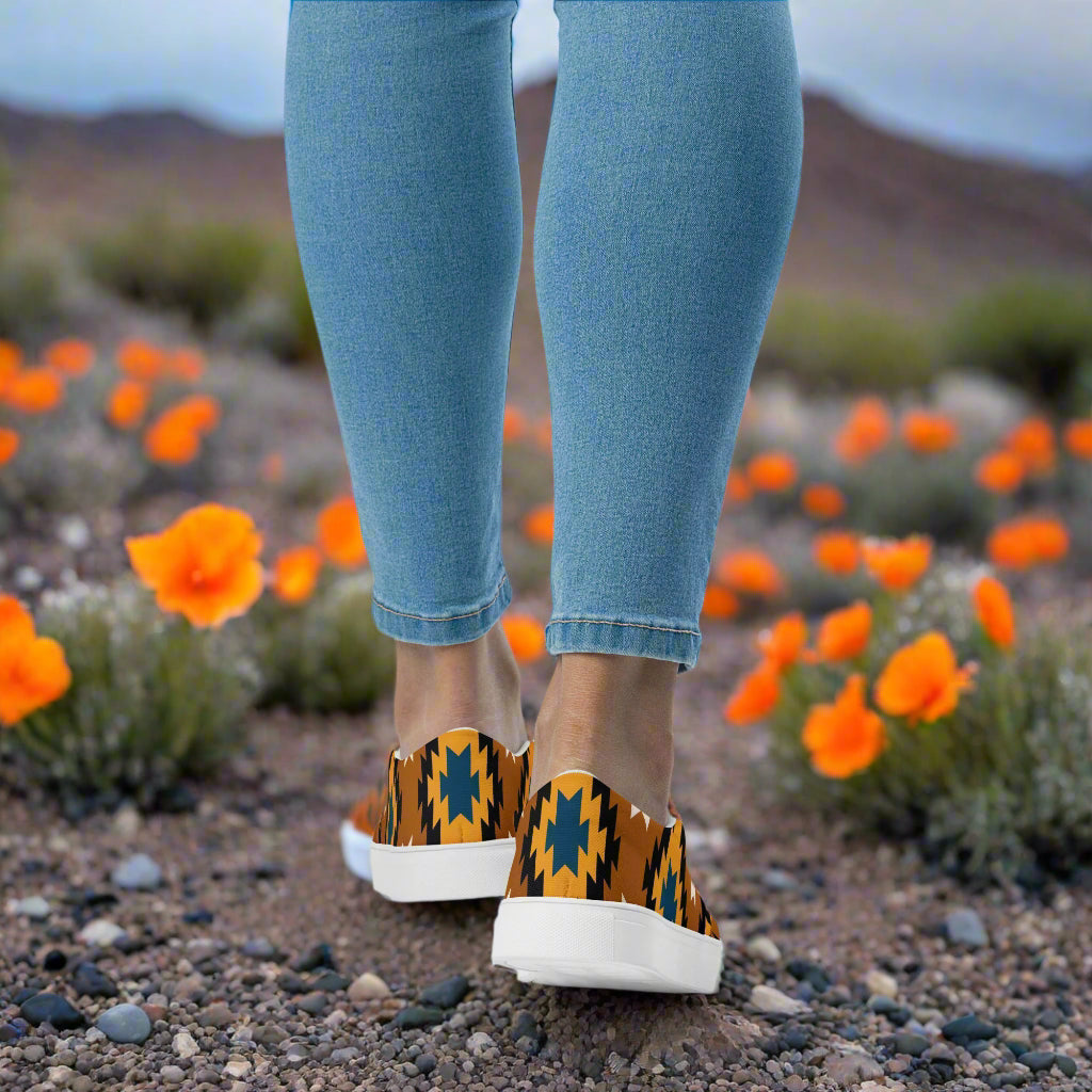 WildSage Market Southwest print slip on canvas shoes Pueblo worn outdoors among orange flowers