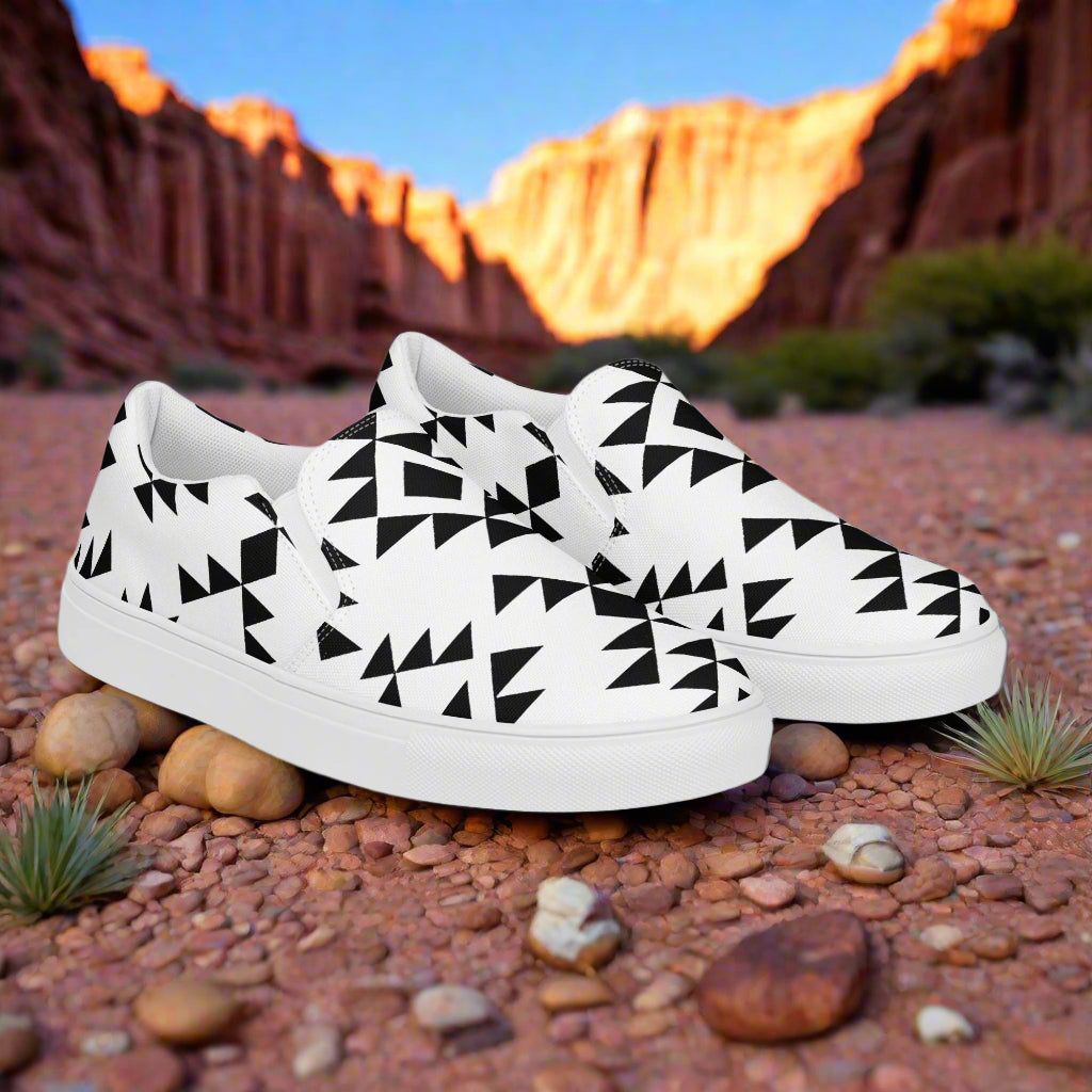 Southwest slip-on canvas shoes Sonora featuring a black and white geometric pattern on a desert background