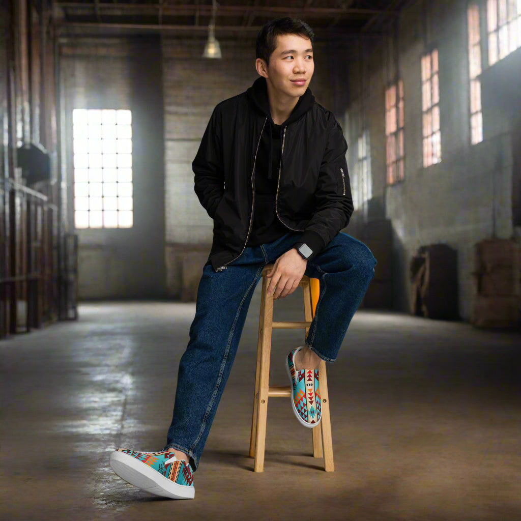 Southwest style mens slip-on canvas shoes worn by a model in a stylish industrial setting
