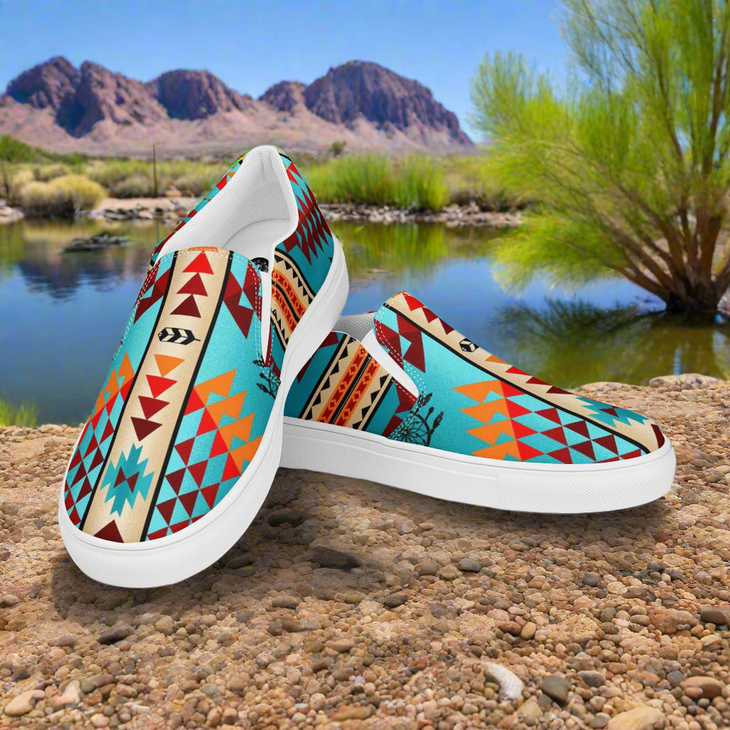 Southwest style mens slip-on canvas shoes featuring vibrant tribal patterns against a desert landscape
