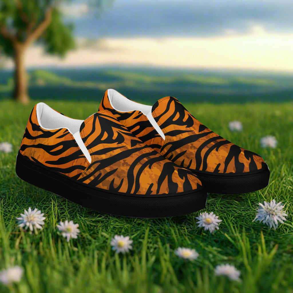 WildSage Market tiger print slip on shoes with black soles on grass with white flowers