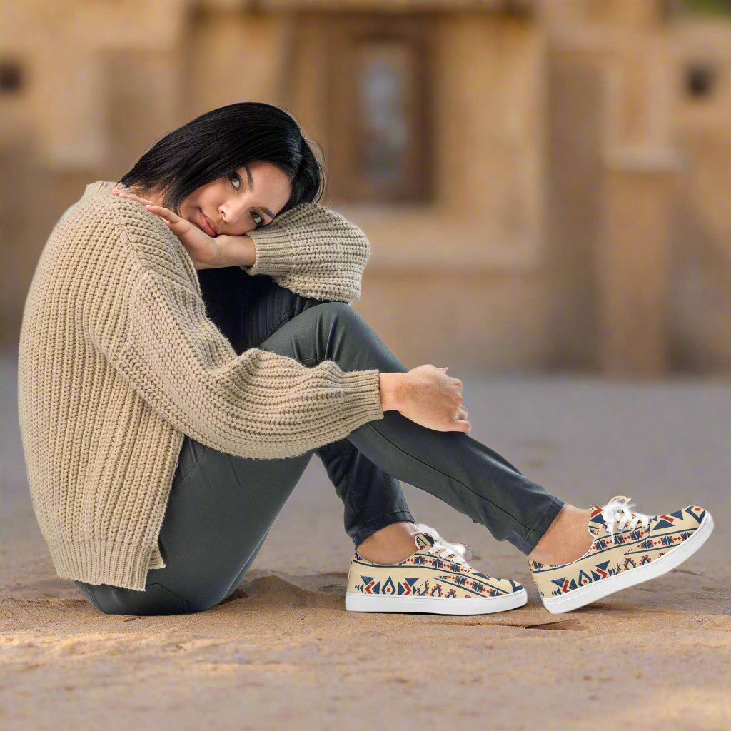 Custom Lace-up Canvas Shoes by WildSage Market worn by seated woman in beige sweater showing tribal print