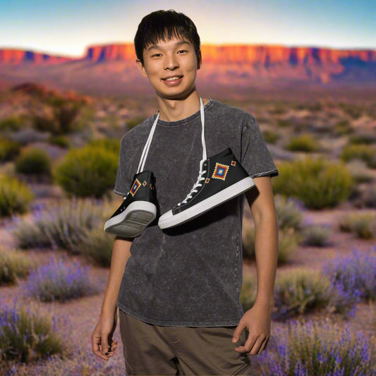WildSage Market High Top Canvas Shoes black patterned high top sneakers slung over shoulder in desert landscape