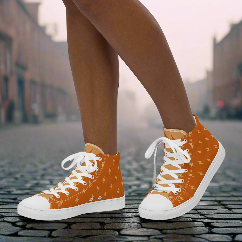 WildSage Market High Top Canvas Shoes in orange lightning print with white laces and rubber toe cap on city street