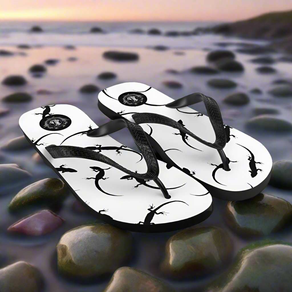 White lizard print flip-flops with black straps, perfect for summer beach outings