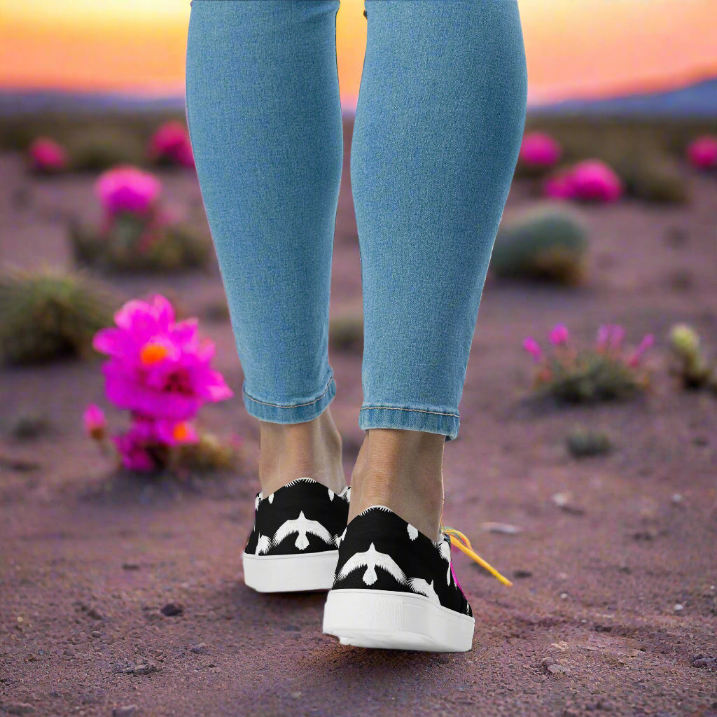 WildSage Market white Ravens slip on canvas shoes worn outdoors with blue jeans and desert flowers