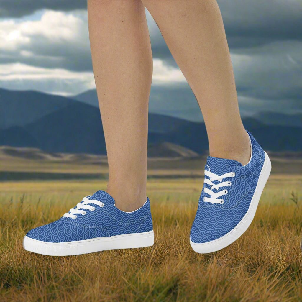 Custom Lace-up Canvas Shoes by WildSage Market blue wave pattern with white laces and sole on grassy field