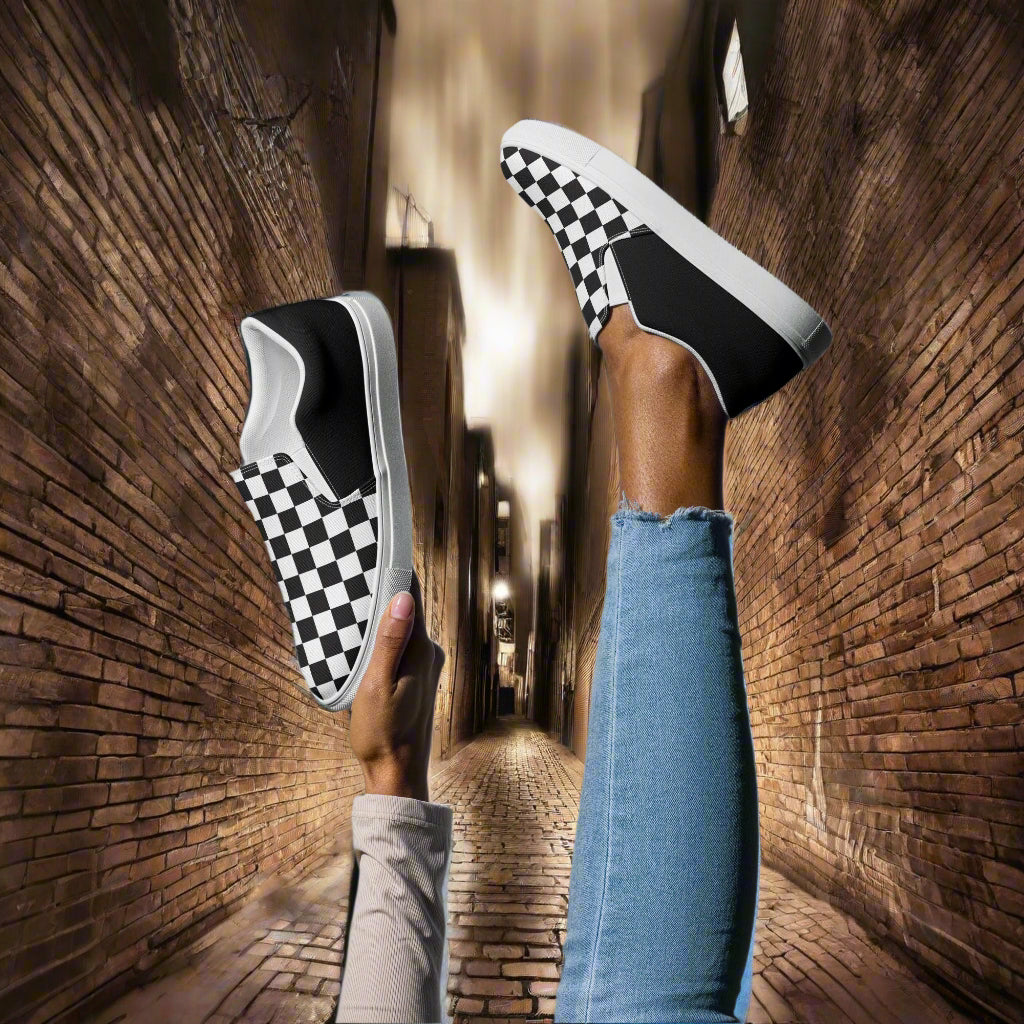Stylish Black Chex Halftone Slip-on Canvas Shoes displayed with legs up in a narrow alley