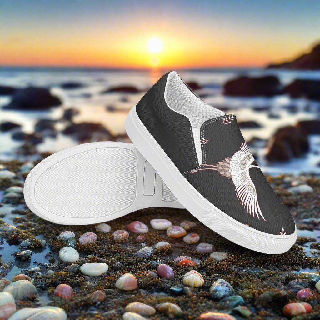 Black Crane Halftone Slip-on Canvas Shoes with Elegant Crane Design on a Scenic Beach Background