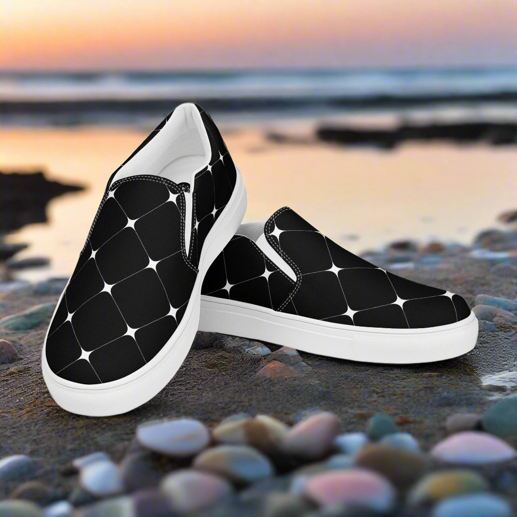 Black Diamond Slip-on Canvas Shoes featuring a stylish pattern on a scenic beach background