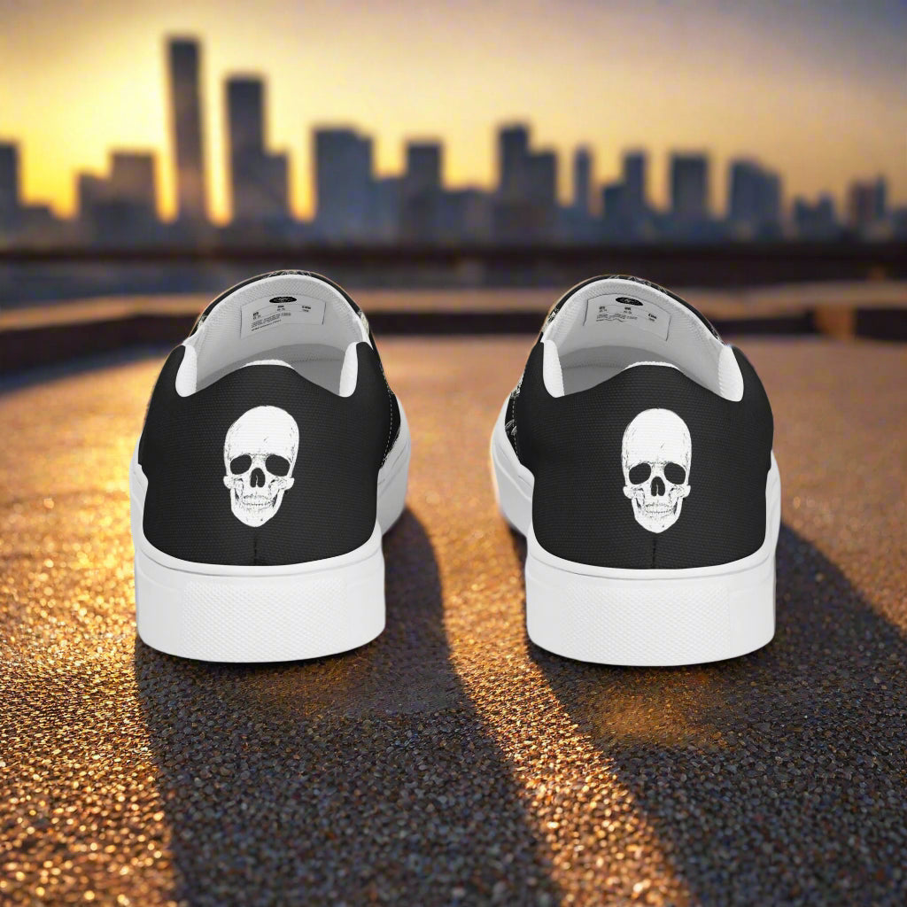 Black Skulls Halftone Slip-On Canvas Shoes with Skull Design on a Sunset Background