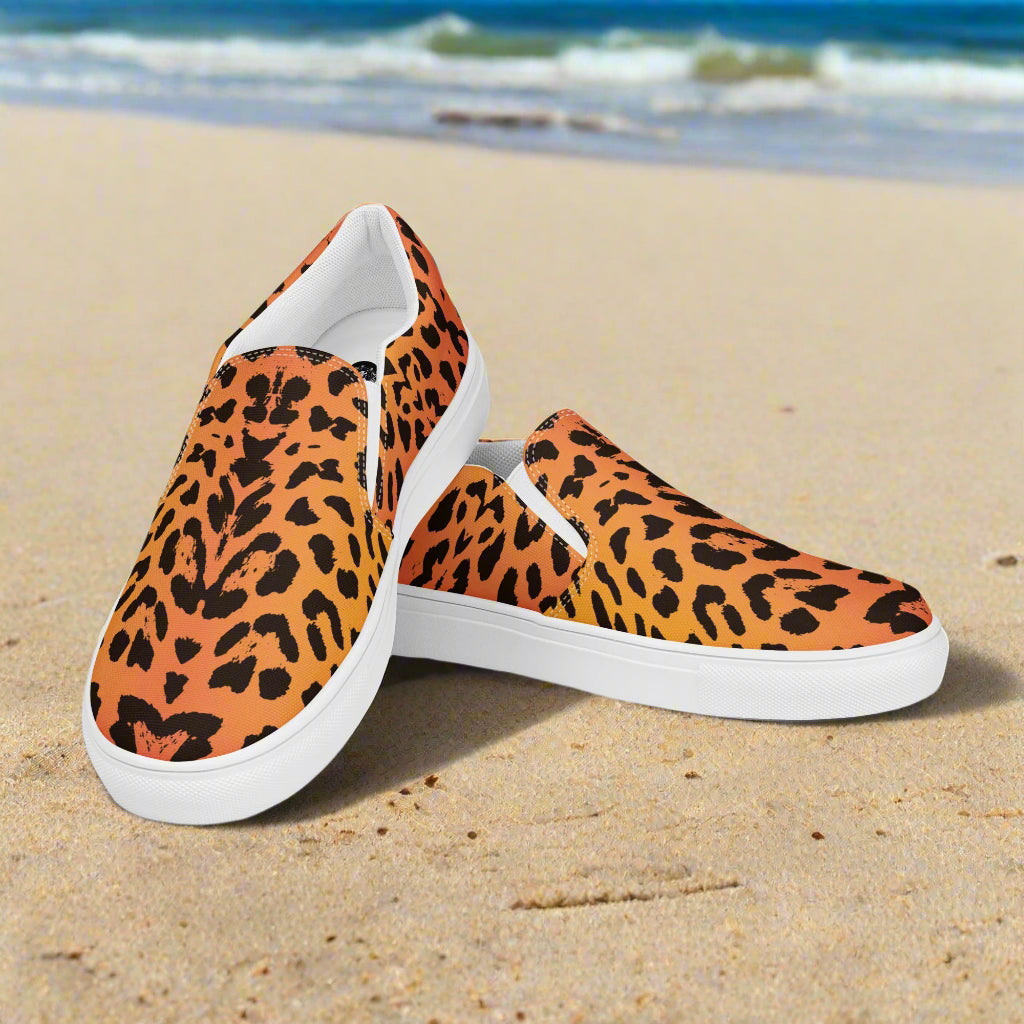 WildSage Market cheetah print slip on shoes with white soles on sandy beach background
