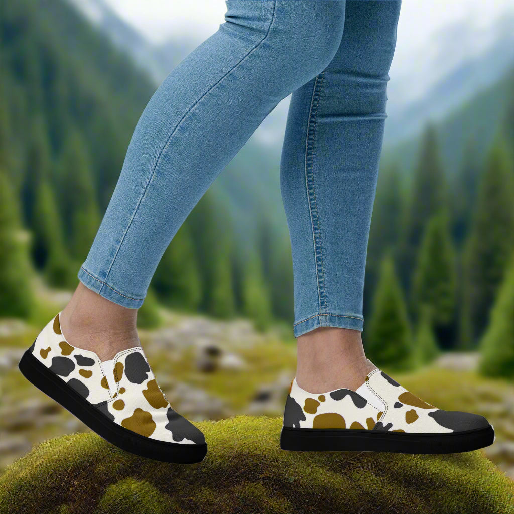 Cowhide Brown and Black Slip-on Canvas Shoes on a model's feet in a natural outdoor setting