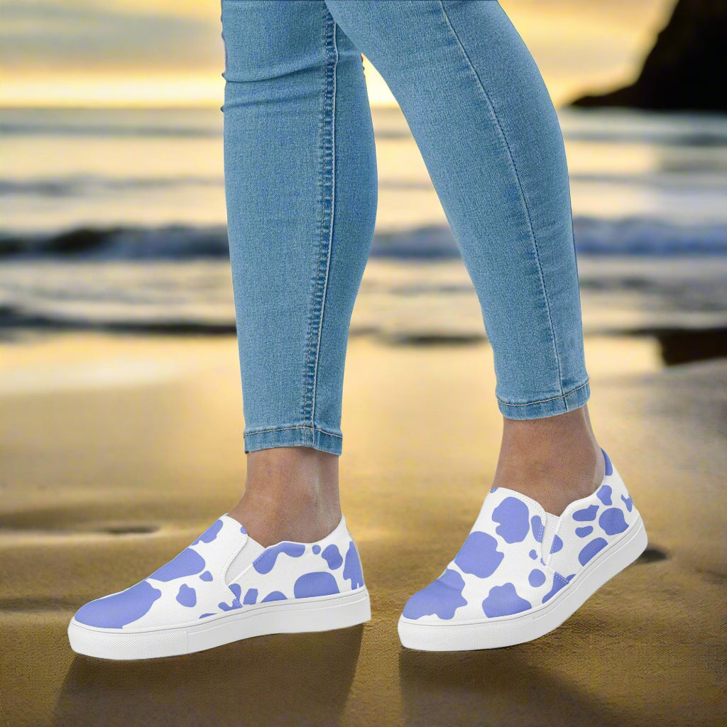 WildSage Cowhide Purple Slip-on Canvas Shoes showcased on a beach with casual jeans