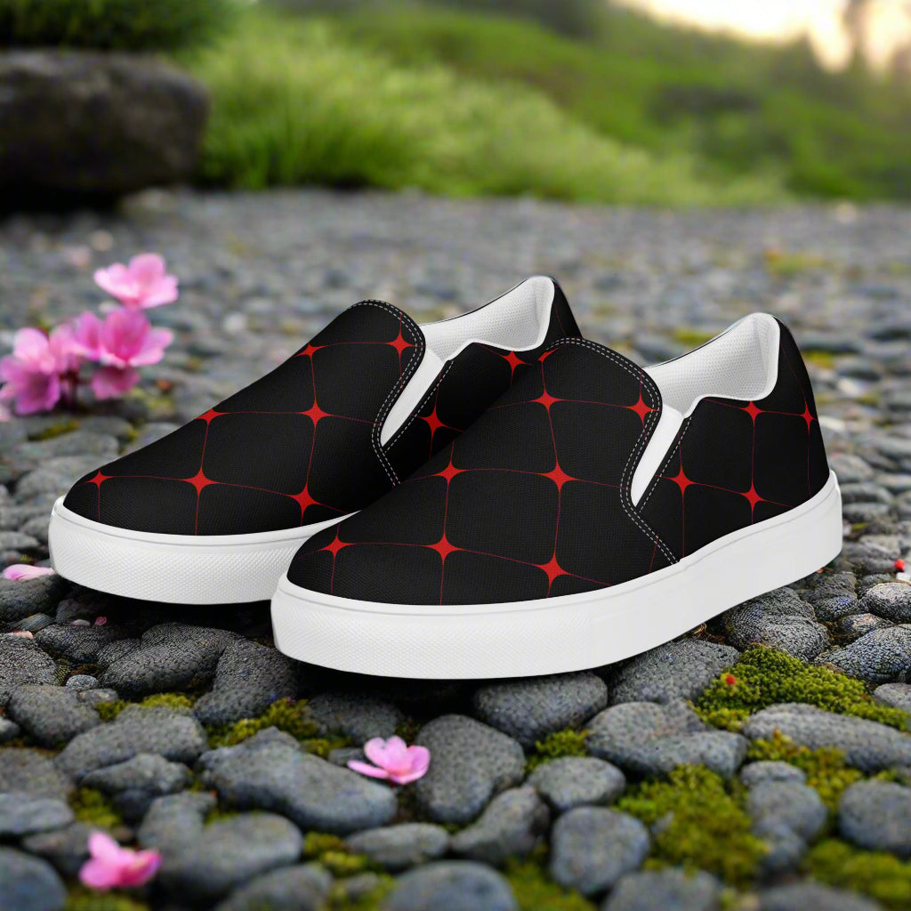 Crimson Diamond Slip-on Canvas Shoes with a stylish black and red geometric pattern on a natural stone background