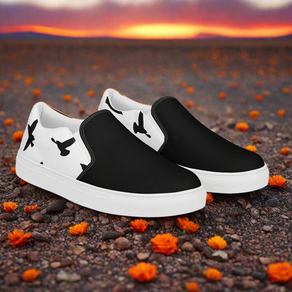 WildSage Market black and white Slip-on Canvas Shoes with bird silhouette heel design on desert flowers backdrop