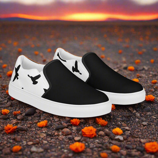 WildSage Market black and white Slip-on Canvas Shoes with bird silhouette heel design on desert flowers backdrop